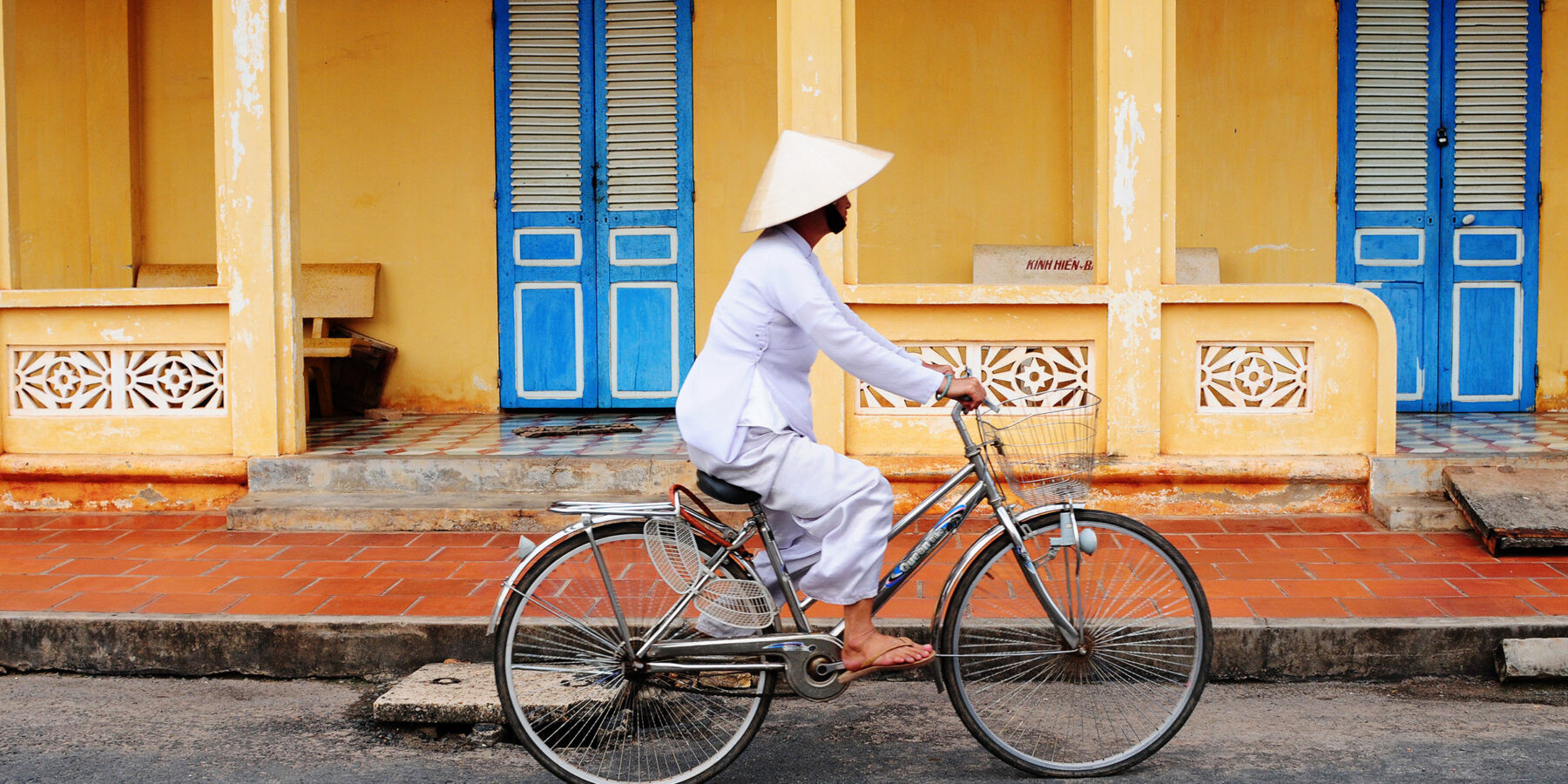 Vietnamese woman rides her bicycle