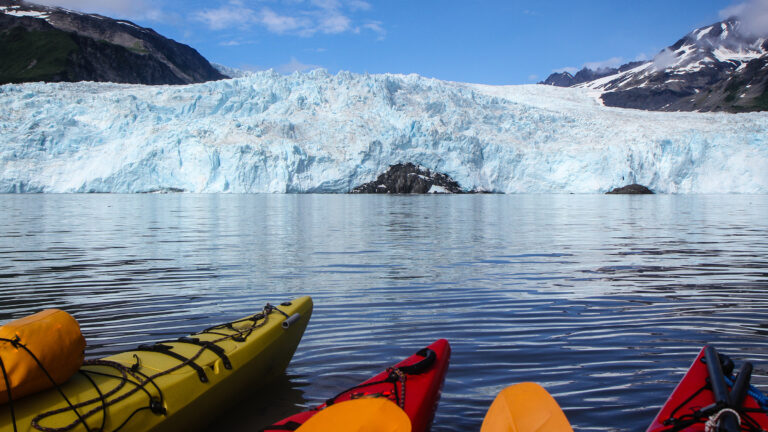 Tips,Of,Colorful,Canoes,In,Front,Of,Aialik,Glacier,,Aialik