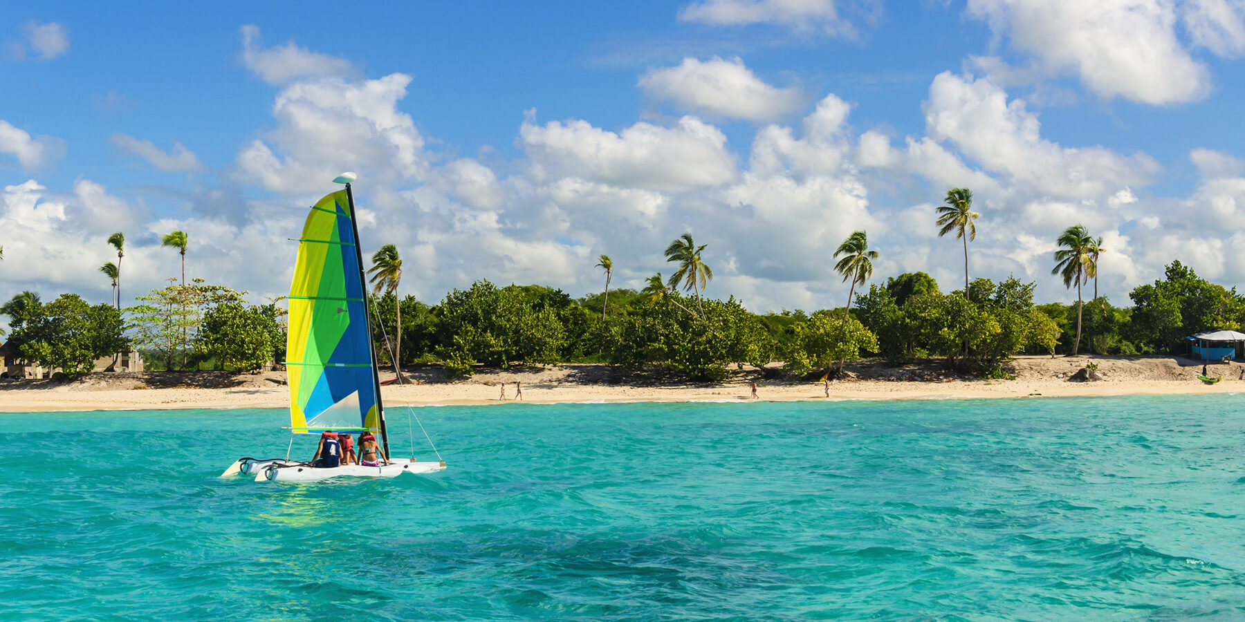 Colorful,Catamaran,On,Azure,Water,Against,Blue,Sky,And,Exotic