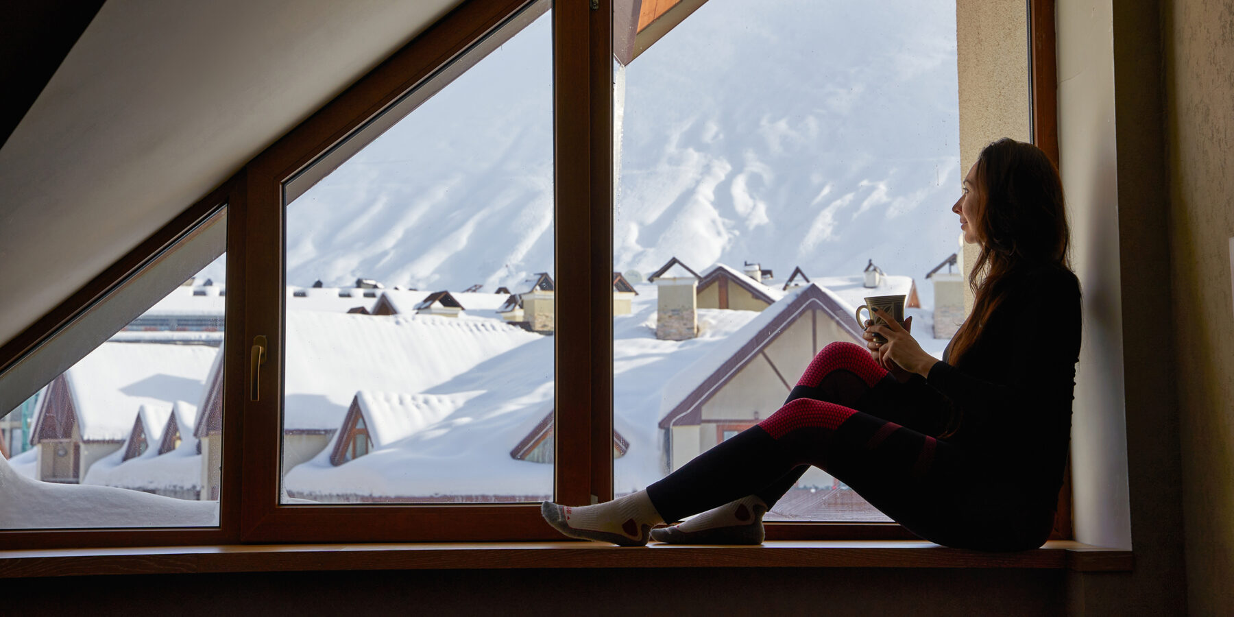 Woman,Being,Cold,Sits,On,Windowsill,,Warming,Up,With,Tea