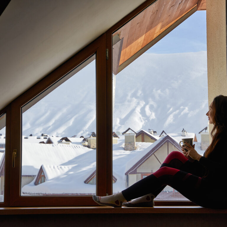 Woman,Being,Cold,Sits,On,Windowsill,,Warming,Up,With,Tea