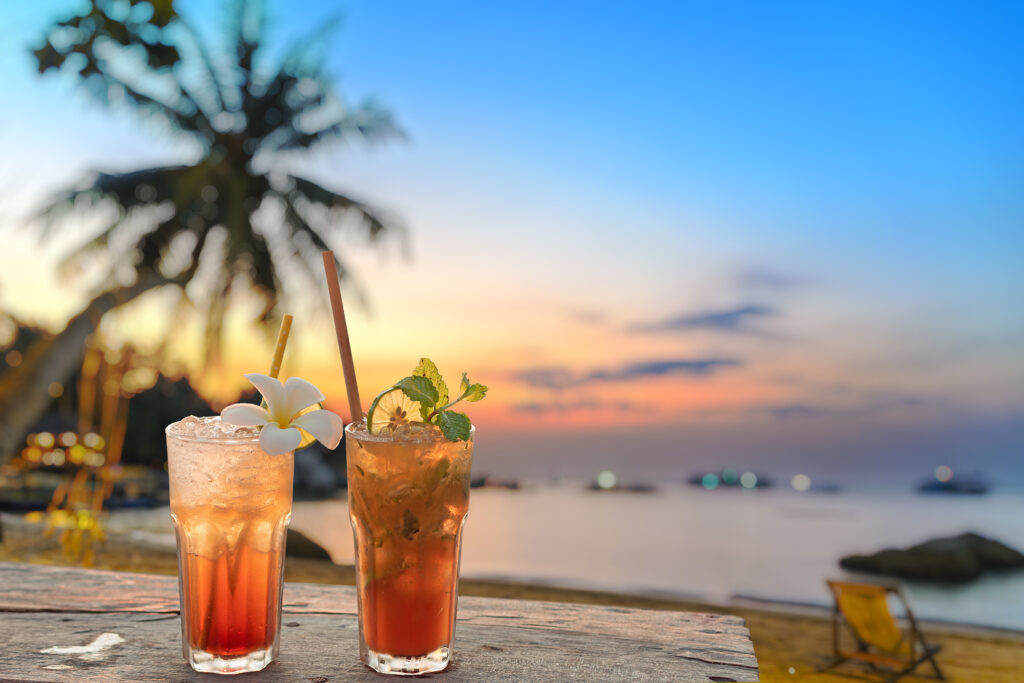 Drinks,With,Blur,Beach,And,Sunset,In,Background