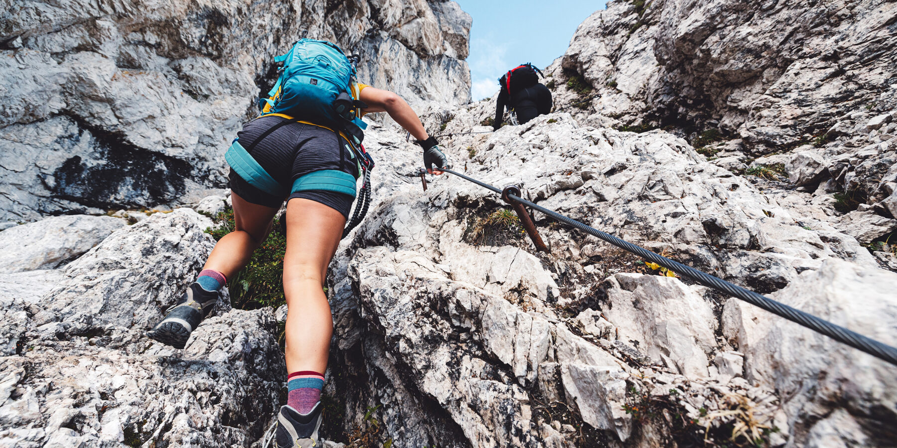 View,From,The,Back,Looking,Up,At,Woman,Mountaineer,In