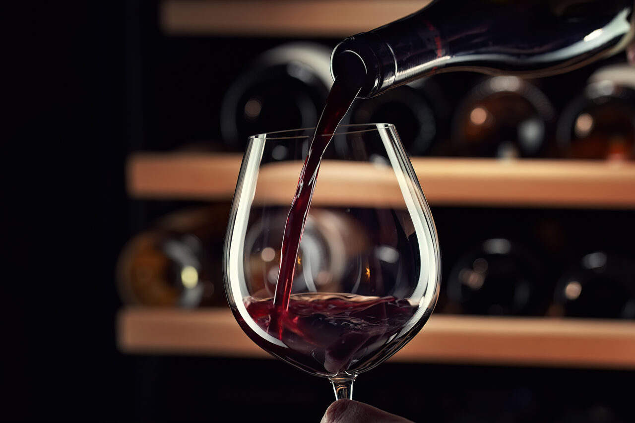 Close,Up,Female,Hand,Pouring,Red,Wine,To,Glass.,Wine