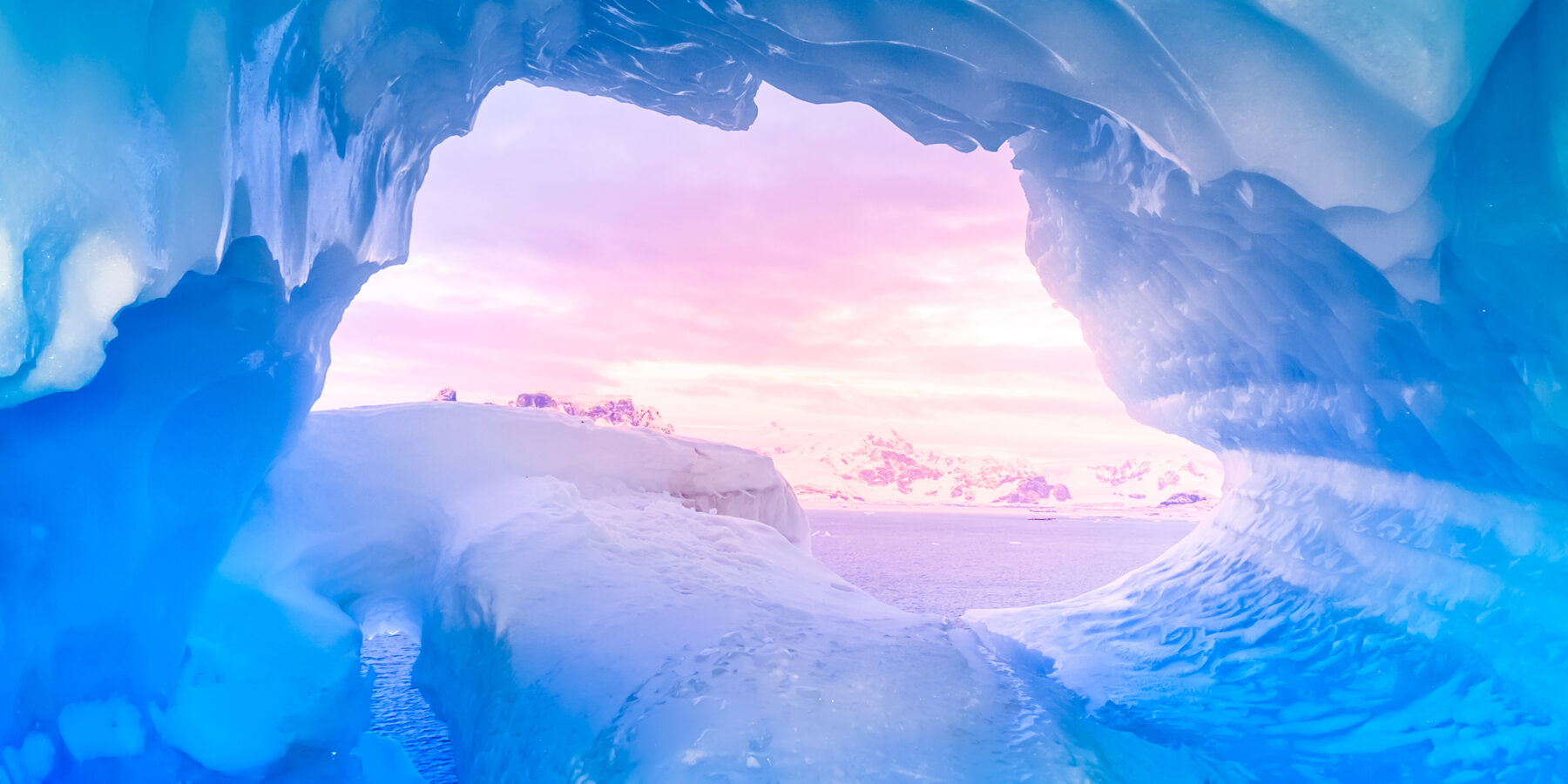 Blue,Ice,Cave,Covered,With,Snow,And,Flooded,With,Light