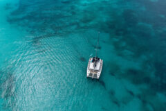 Small,Catamaran,In,The,Middle,Of,The,Blue,Sea,Of