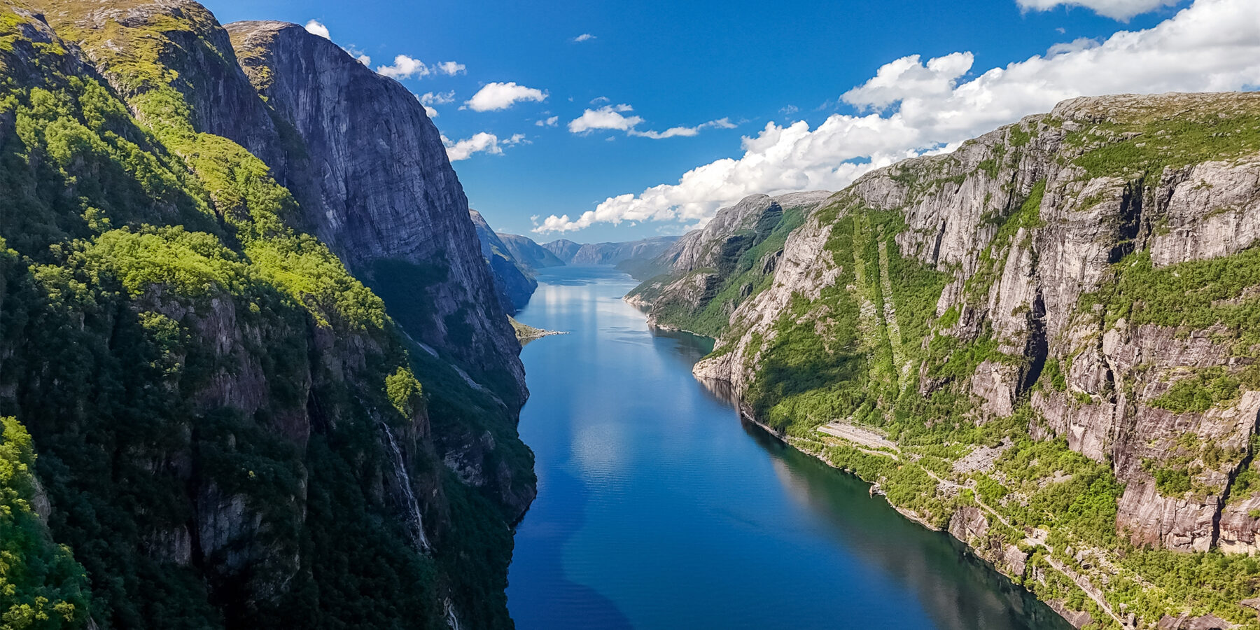 A,Breathtaking,View,Of,A,Norwegian,Fjord,,Showcasing,Towering,Cliffs,