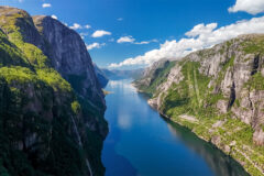 A,Breathtaking,View,Of,A,Norwegian,Fjord,,Showcasing,Towering,Cliffs,