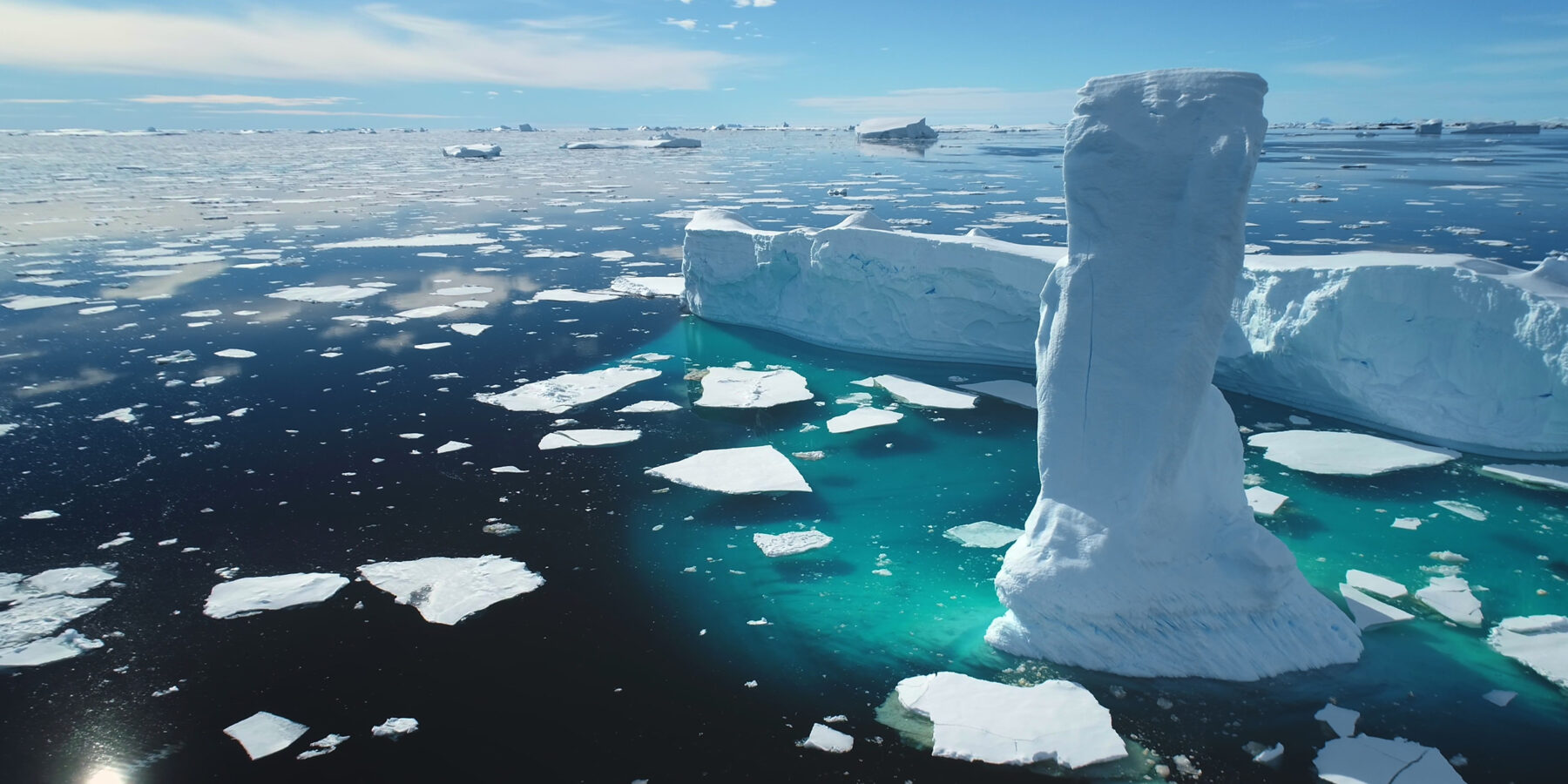 Towering,Melting,Iceberg,In,Arctic,Icy,Ocean.,Snow,Covered,Glacier