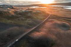 Cinematic,Aerial,Image,Of,A,Car,Driving,On,An,Empty