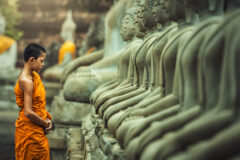 Novices,Monk,Vipassana,Meditation,At,Front,Of,Buddha,Statue